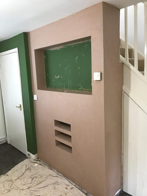 The same under-stairs wall after plastering
